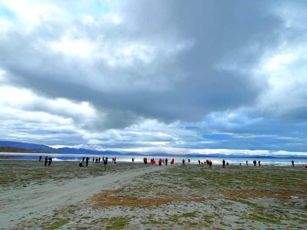 Pilgrims at Lake Mansarovar performing rituals and prayers on the lakeside